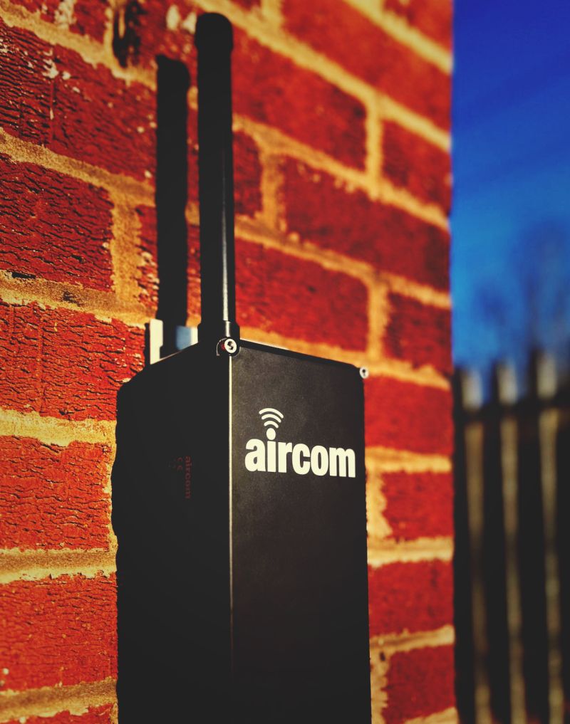 Aircom sunshine brick wall blue sky